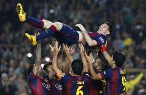 Barcelona's Messi celebrates his second goal with teammates during their Spanish first division soccer match against Sevilla at Nou Camp stadium in Barcelona